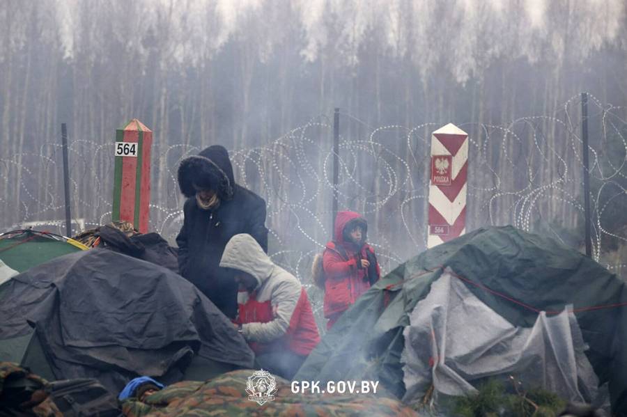 In this handout photo released by State Border Committee of the Republic of
Belarus on Wednesday, Nov. 10, 2021, Migrants from the Middle East and elsewhere
sit near near the barbed wire gathering at the Belarus-Poland border near
Grodno, Belarus. Thousands of migrants have flocked to Belarus' border with
Poland, hoping to get to Western Europe, and many of them are now stranded at
the frontier, setting up makeshift camps as Polish security forces watch them
from behind a razor-wire fence and prevent them from entering the country....