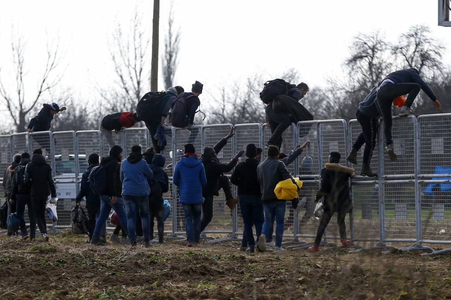 Migrants climb a fence installed by Turkish authorities near the Turkish-Greek
border in Pazarkule on Wednesday, March 4, 2020. Greek authorities fired tear
gas and stun grenades Wednesday morning to repulse a push by migrants to cross
its land border from Turkey, as pressure continued along its frontier after
Turkey said its own border with Europe was open to whoever wanted to cross. (AP...